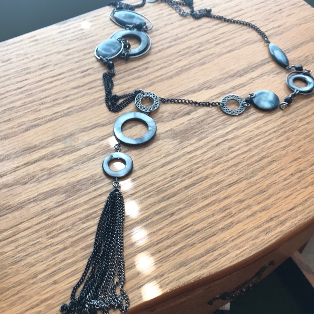 Long black necklace.